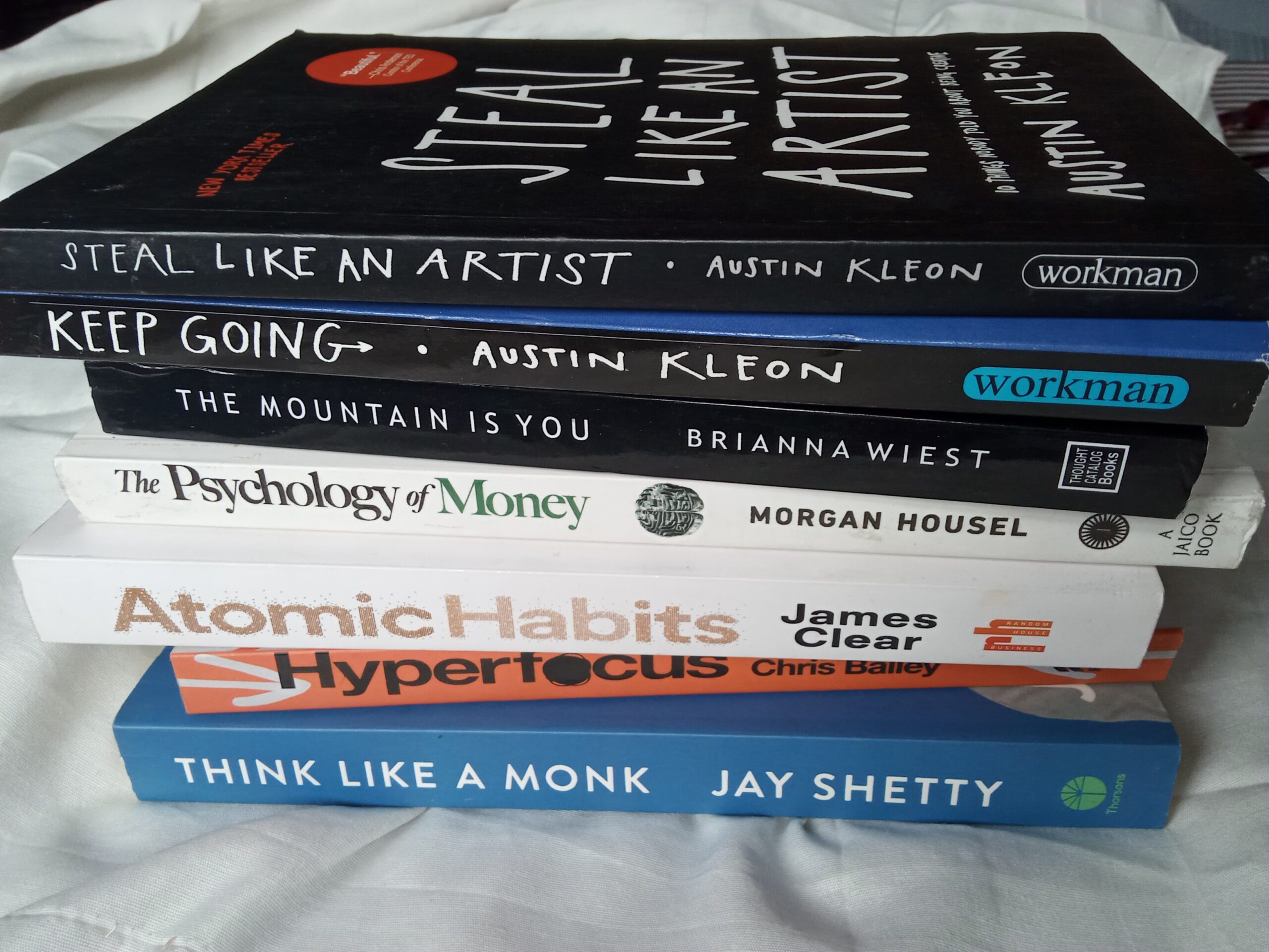 A stack of books kept on a table, all self-help books, personal growth.
