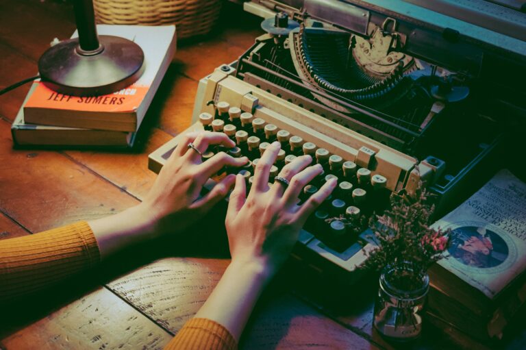 A woman writing on a typewriter.